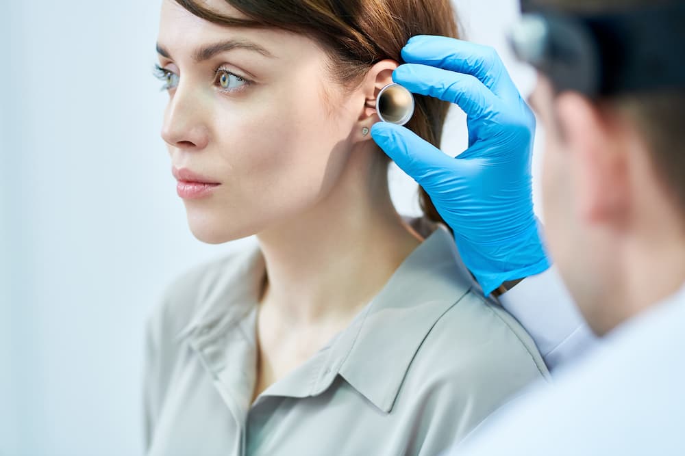audiologist examining ears
