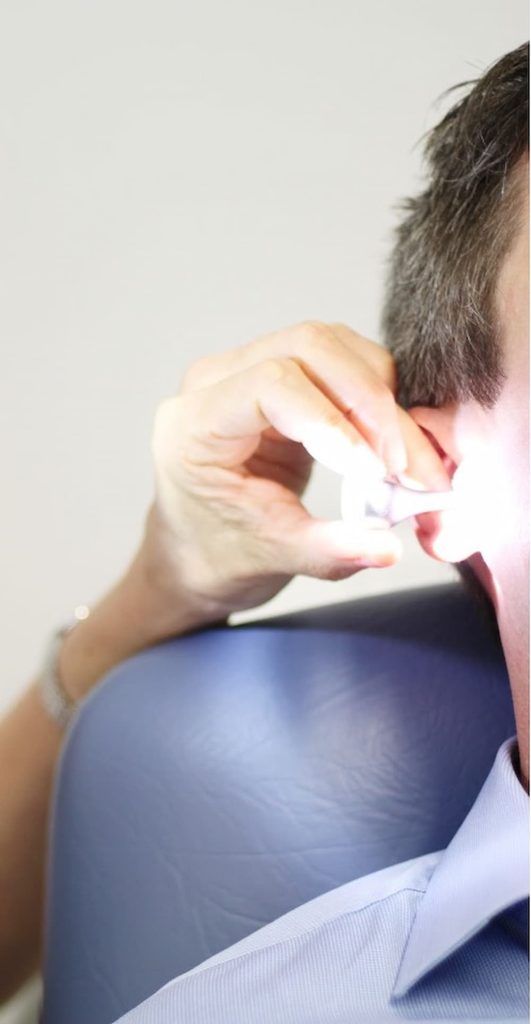 man getting ear checked