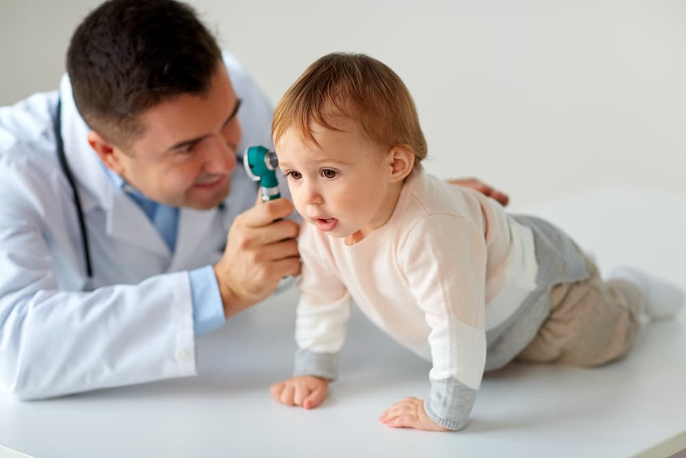 doctor looking at baby's ear